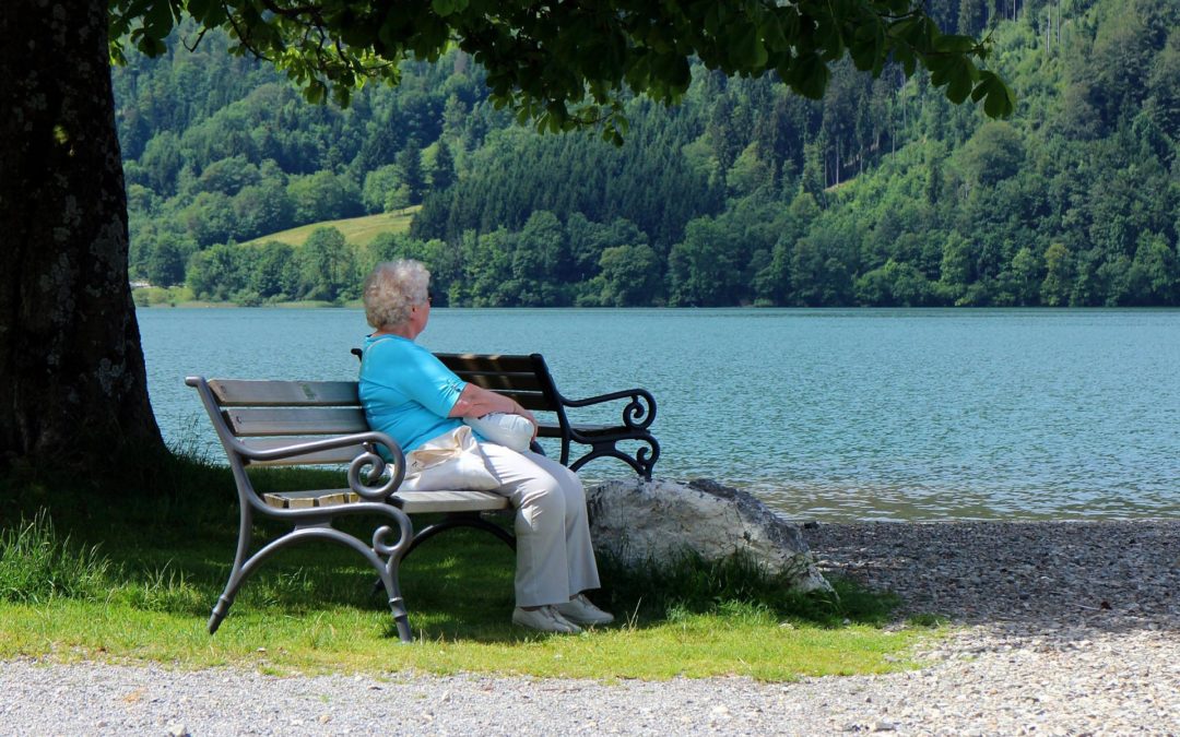 Woman sitting by a serene lake